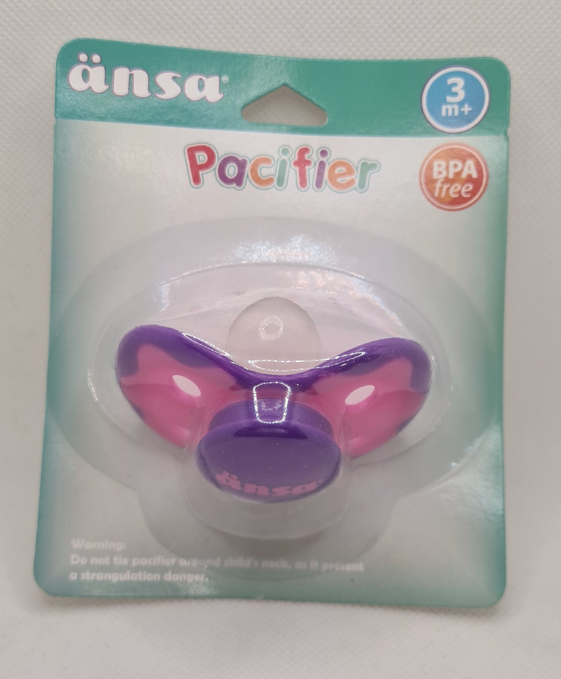 a purple pacifier in a package
