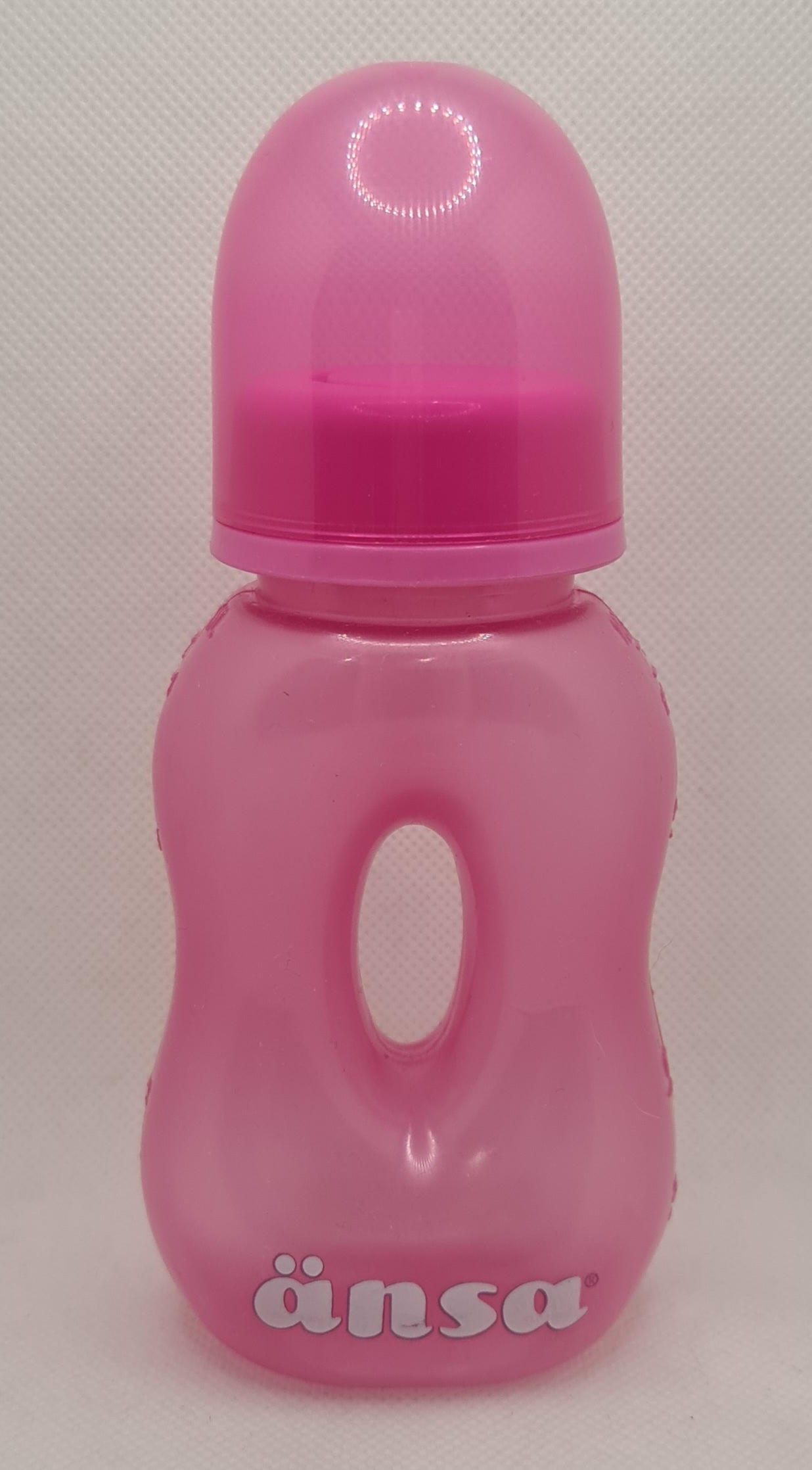 a pink plastic bottle with a hole