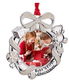 a silver ornament with a picture of children opening a box