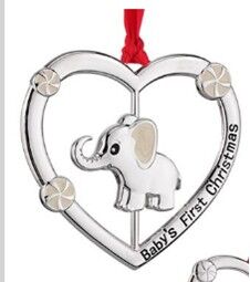 a silver ornament with an elephant in the middle of a heart
