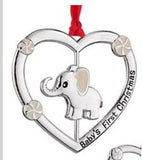 a silver ornament with an elephant in the middle of a heart