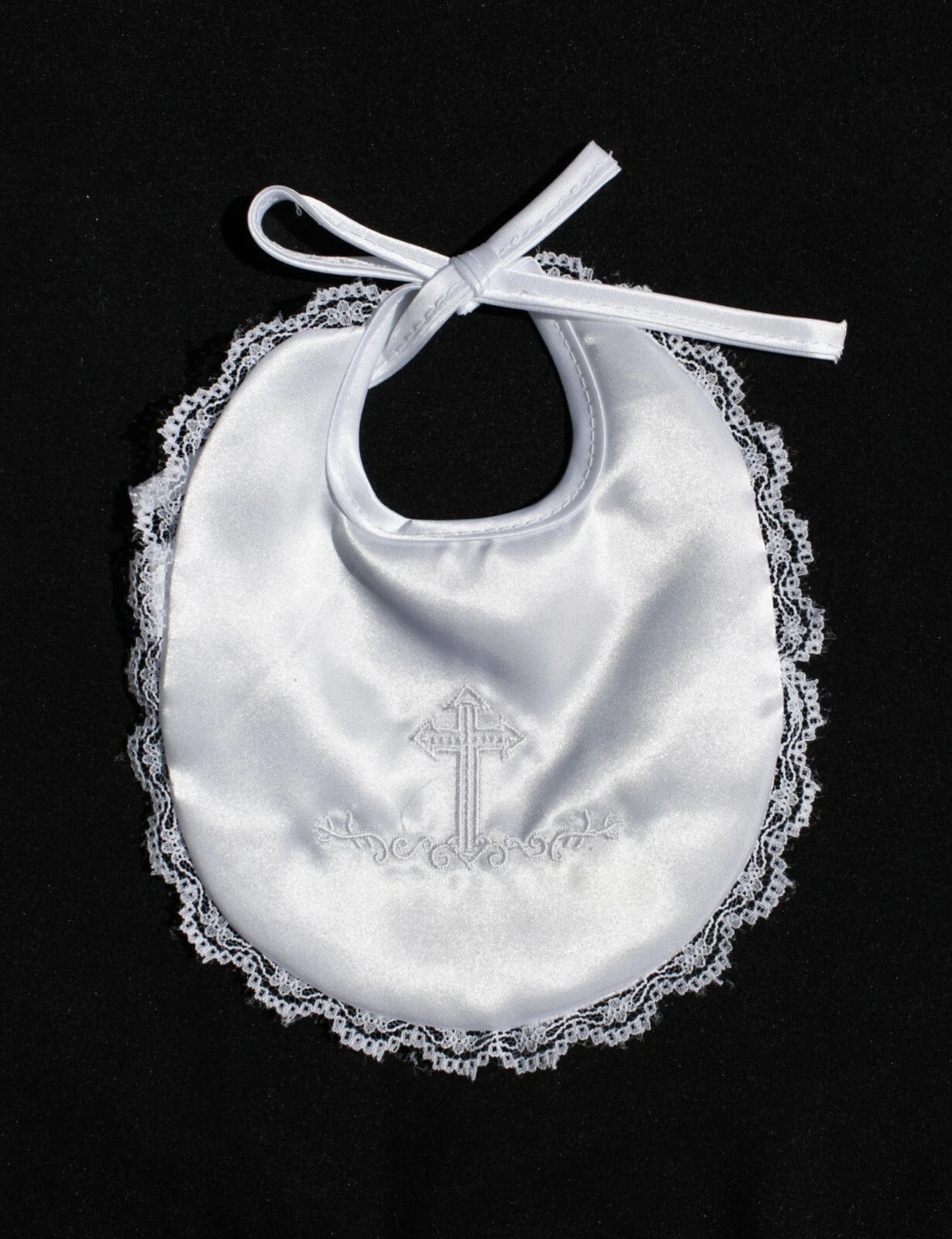 a white baby bib with a cross on it