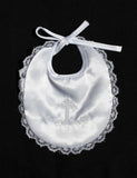 a white baby bib with a cross on it
