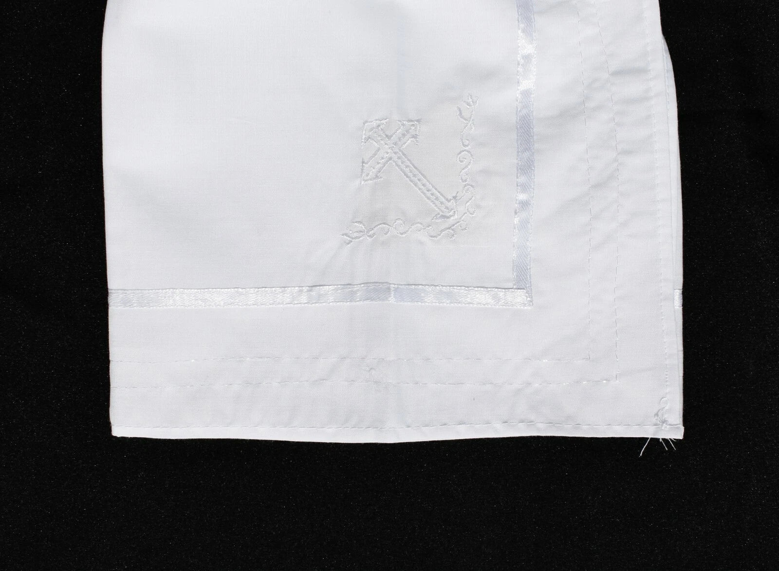 a white handkerchief with a cross on it